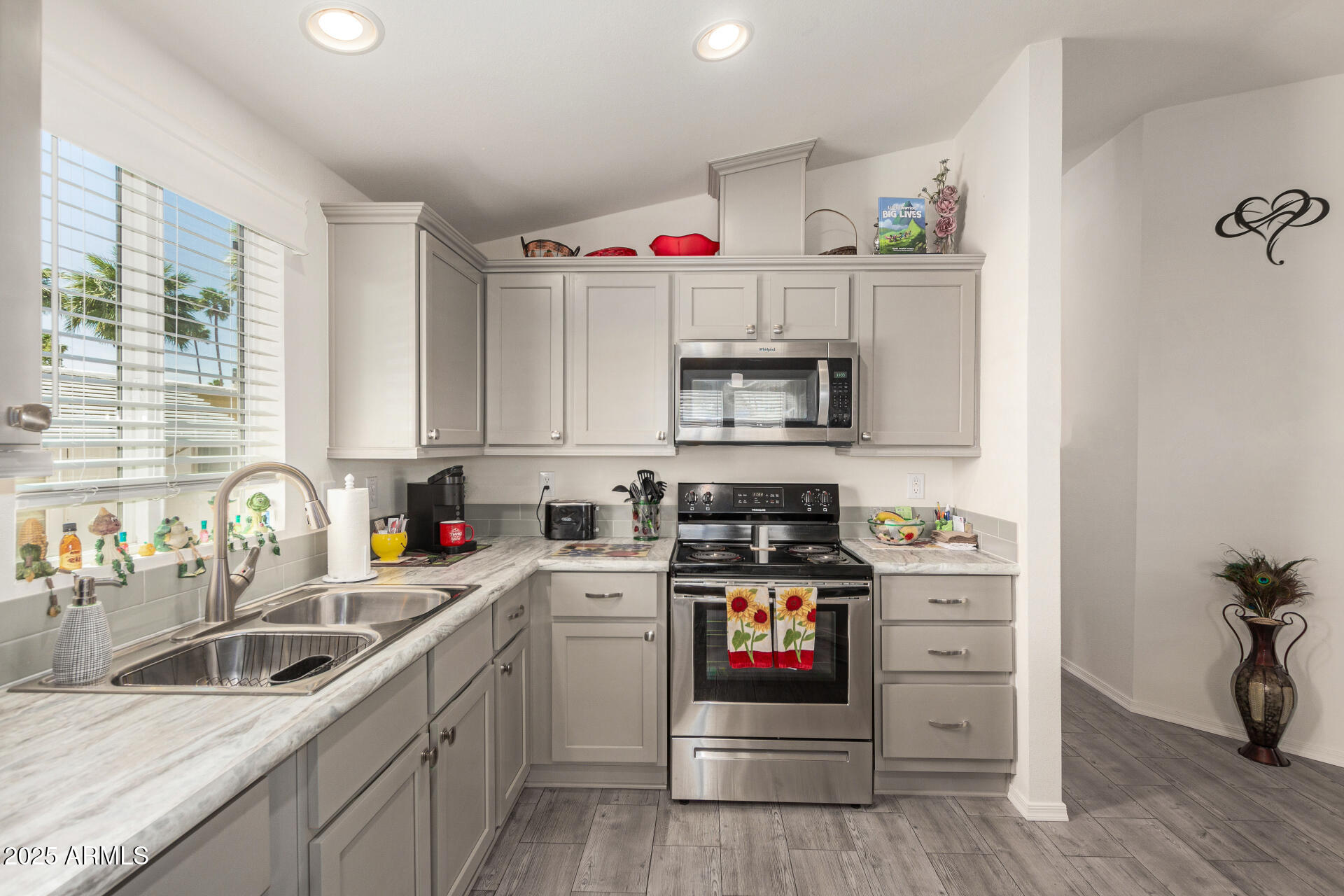 10540 East Apache Trail, Unit 50 Apache Junction, AZ 85120 - Photo 17 of 32 a kitchen with granite countertop a sink cabinets stainless steel appliances and wooden floor