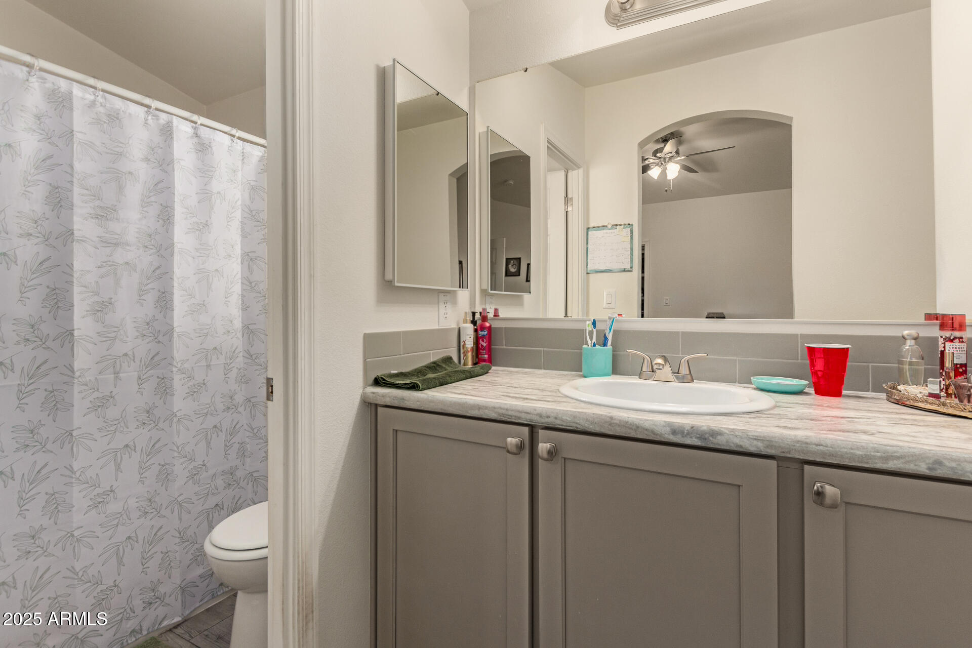 10540 East Apache Trail, Unit 50 Apache Junction, AZ 85120 - Photo 22 of 32 a bathroom with a granite countertop sink and a mirror