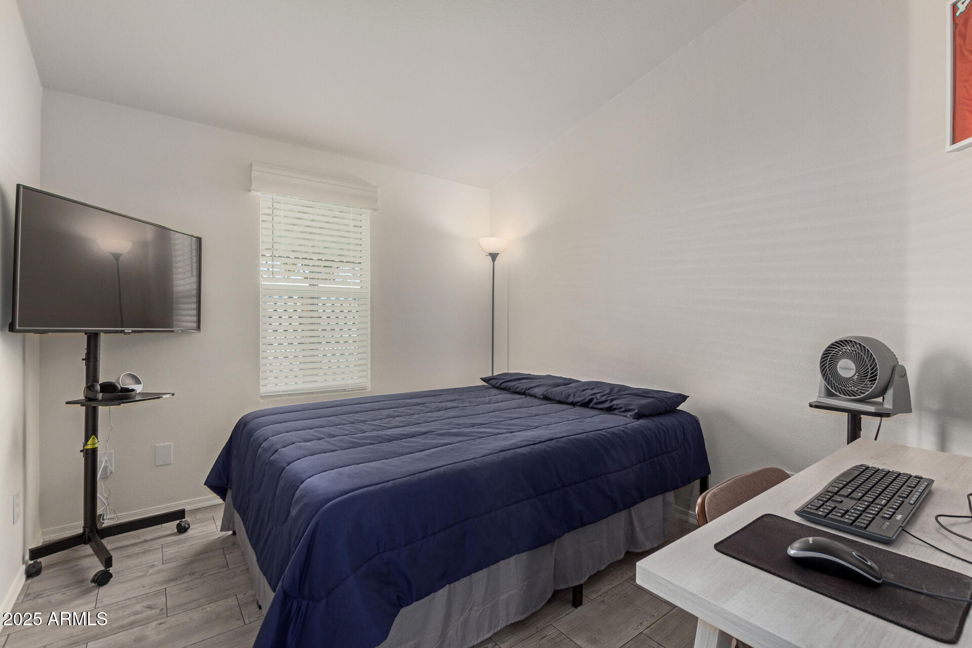 10540 East Apache Trail, Unit 50 Apache Junction, AZ 85120 - Photo 24 of 32 a bedroom with a bed and a flat screen tv