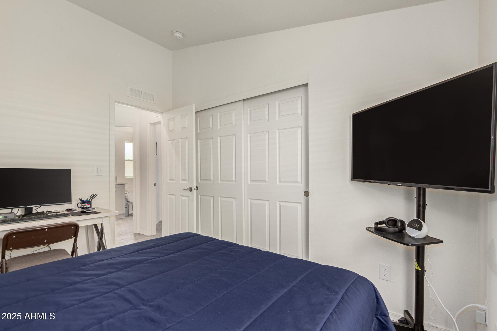 10540 East Apache Trail, Unit 50 Apache Junction, AZ 85120 - Photo 25 of 32 a bedroom with a bed and a flat screen tv