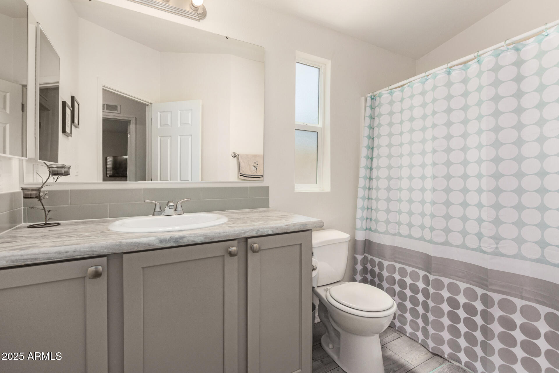 10540 East Apache Trail, Unit 50 Apache Junction, AZ 85120 - Photo 26 of 32 a bathroom with a granite countertop toilet sink and mirror