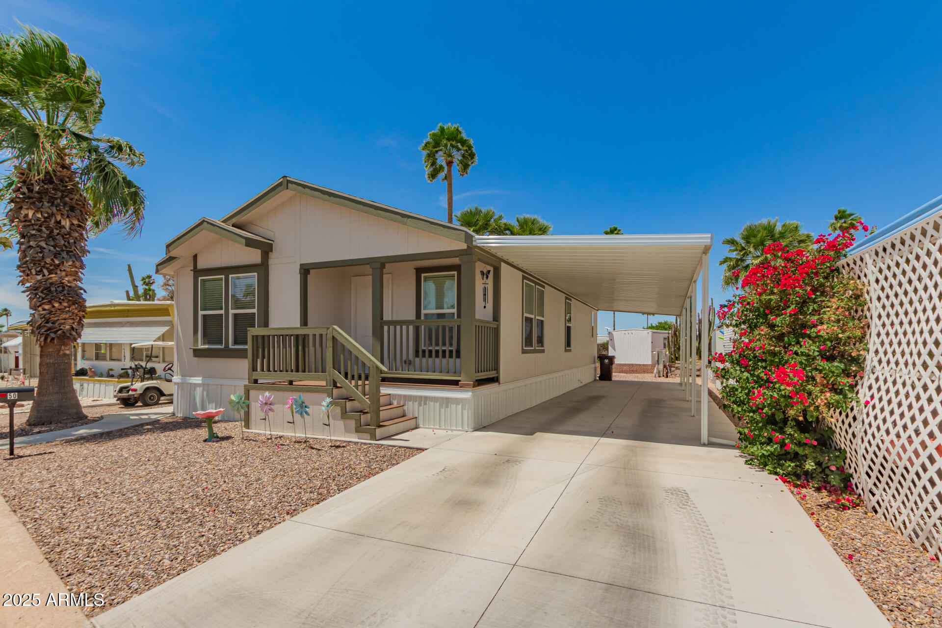 10540 East Apache Trail, Unit 50 Apache Junction, AZ 85120 - Photo 8 of 32 a front view of a house with a yard