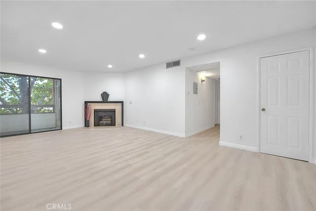 a view of a room with wooden floor and windows
