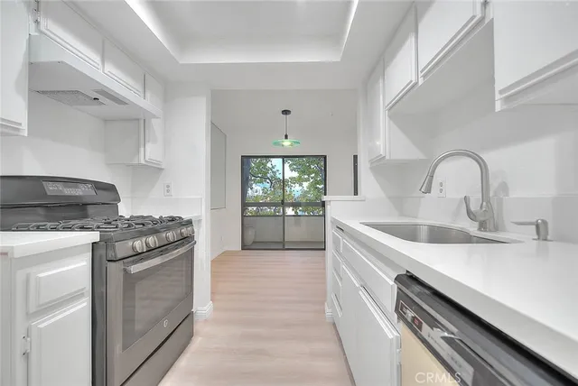 a kitchen that has a sink and a stove