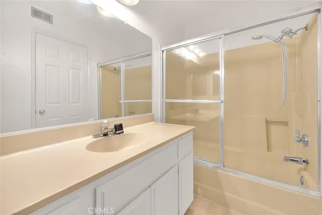 a bathroom with a sink toilet vanity and shower