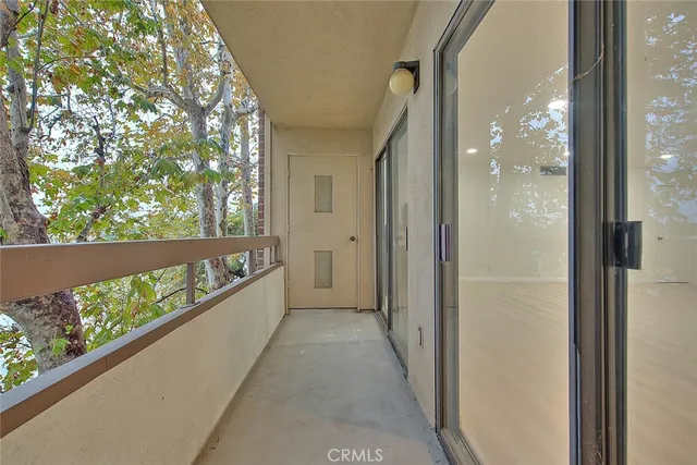 a view of an empty room with a window and fireplace