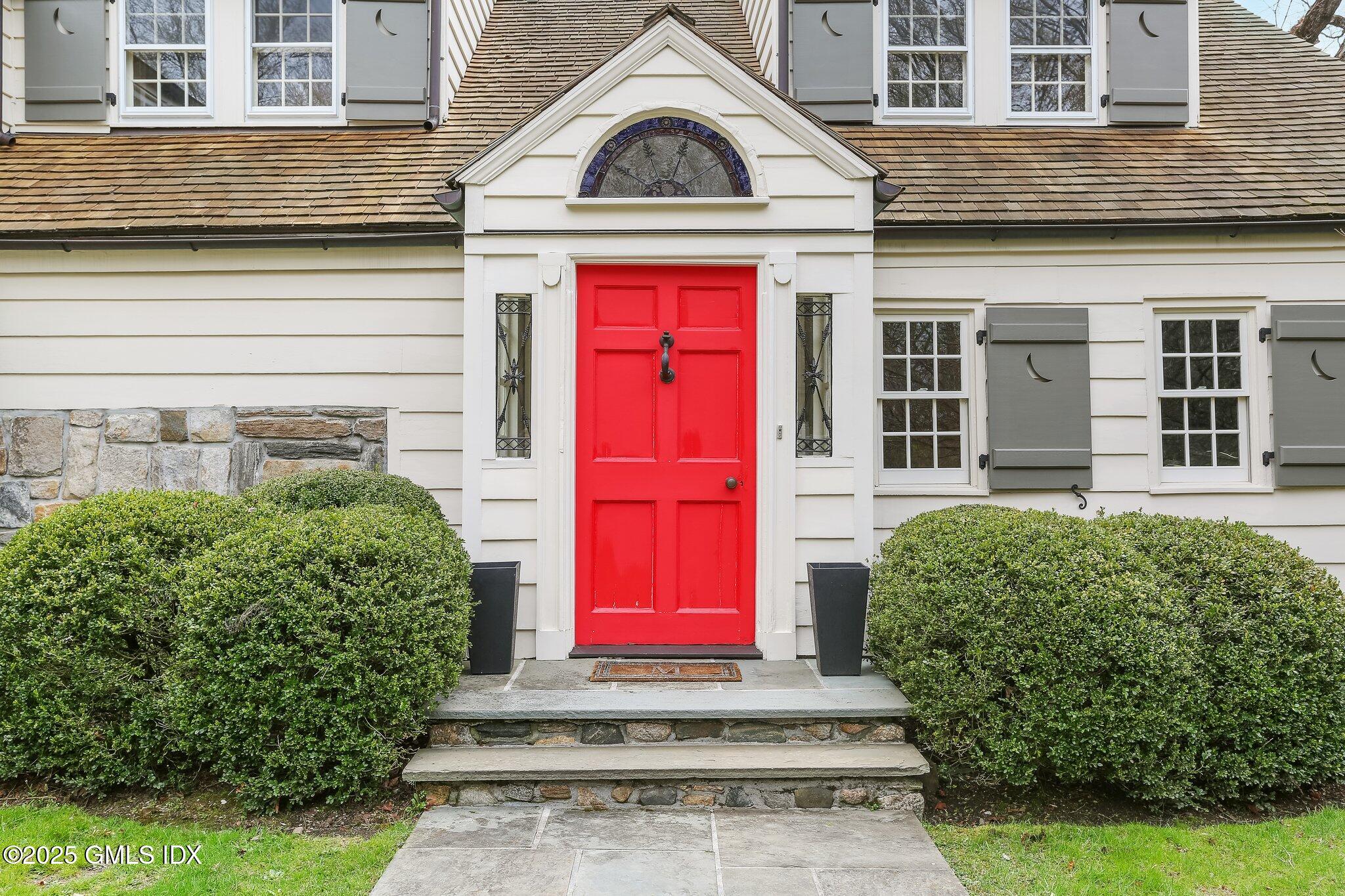 a view of a brick house with potted plants