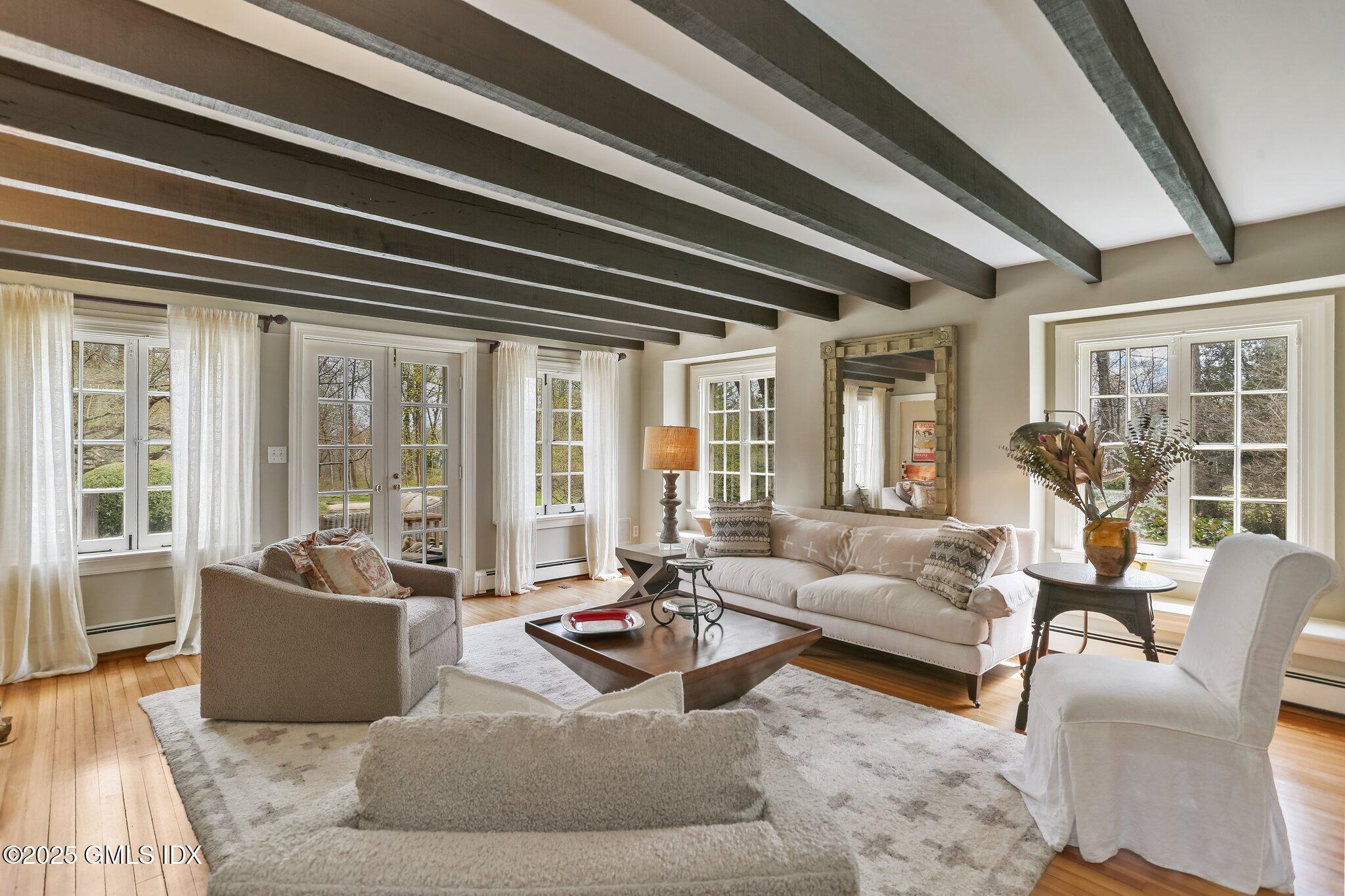 1007 King Street Greenwich, CT 06831 - Photo 11 of 71 a living room with furniture and floor to ceiling windows