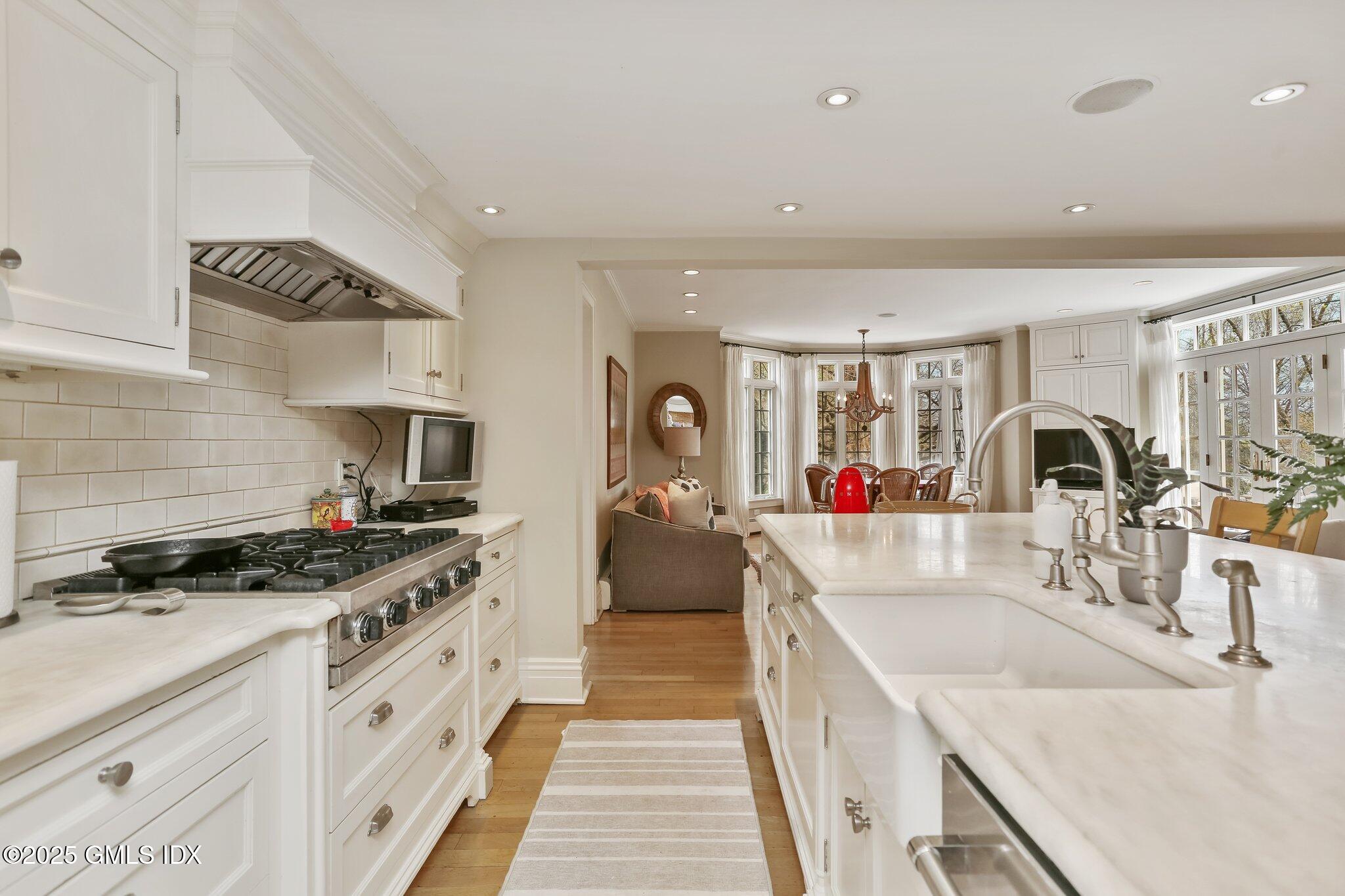 1007 King Street Greenwich, CT 06831 - Photo 18 of 71 a kitchen with sink stove and cabinets