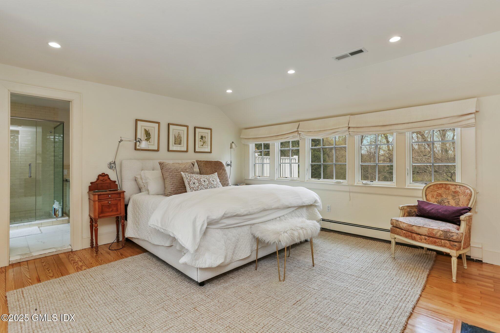 1007 King Street Greenwich, CT 06831 - Photo 36 of 71 a spacious bedroom with a bed and glass window
