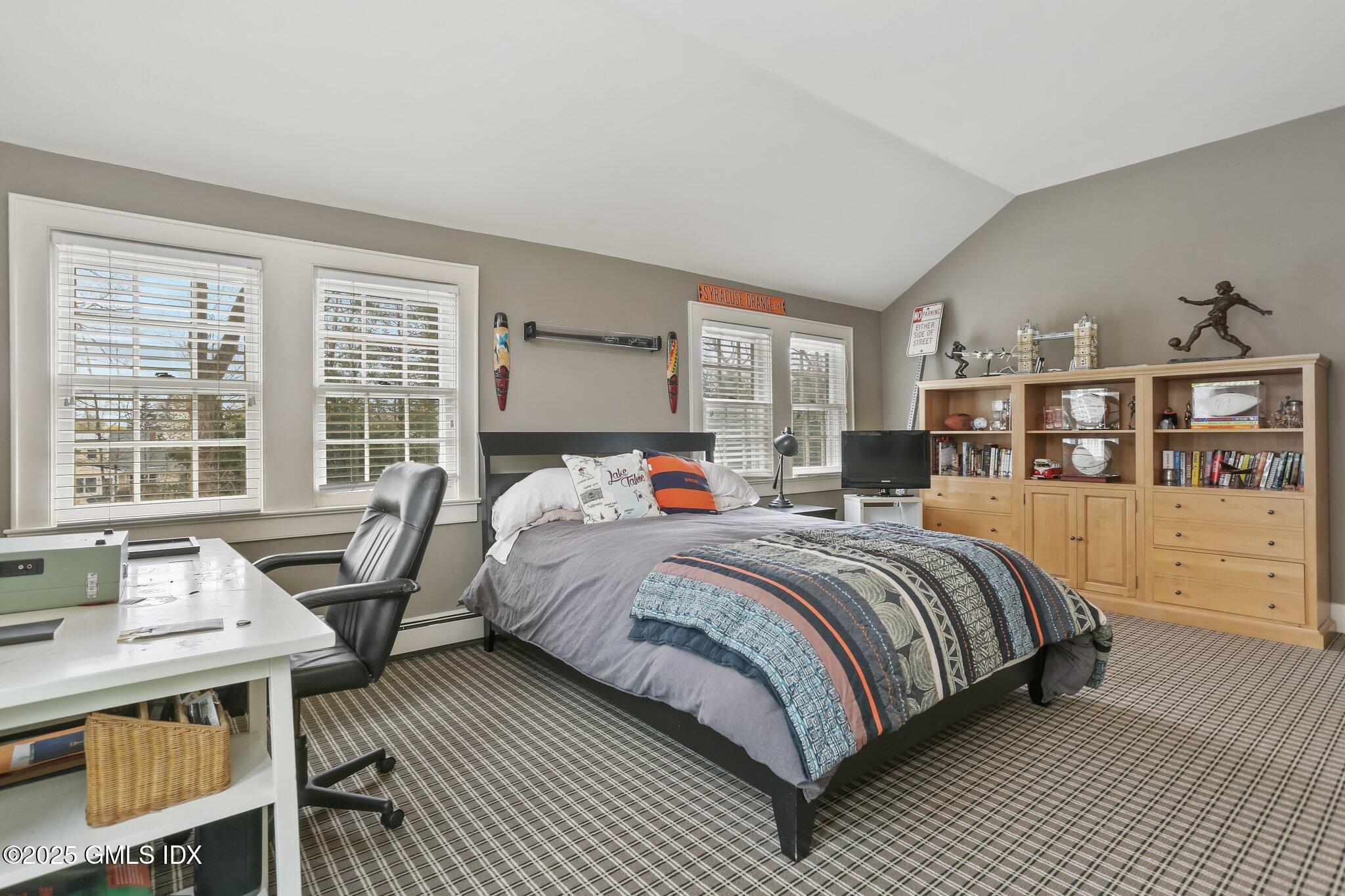 1007 King Street Greenwich, CT 06831 - Photo 40 of 71 a bedroom with a bed a dresser and large windows