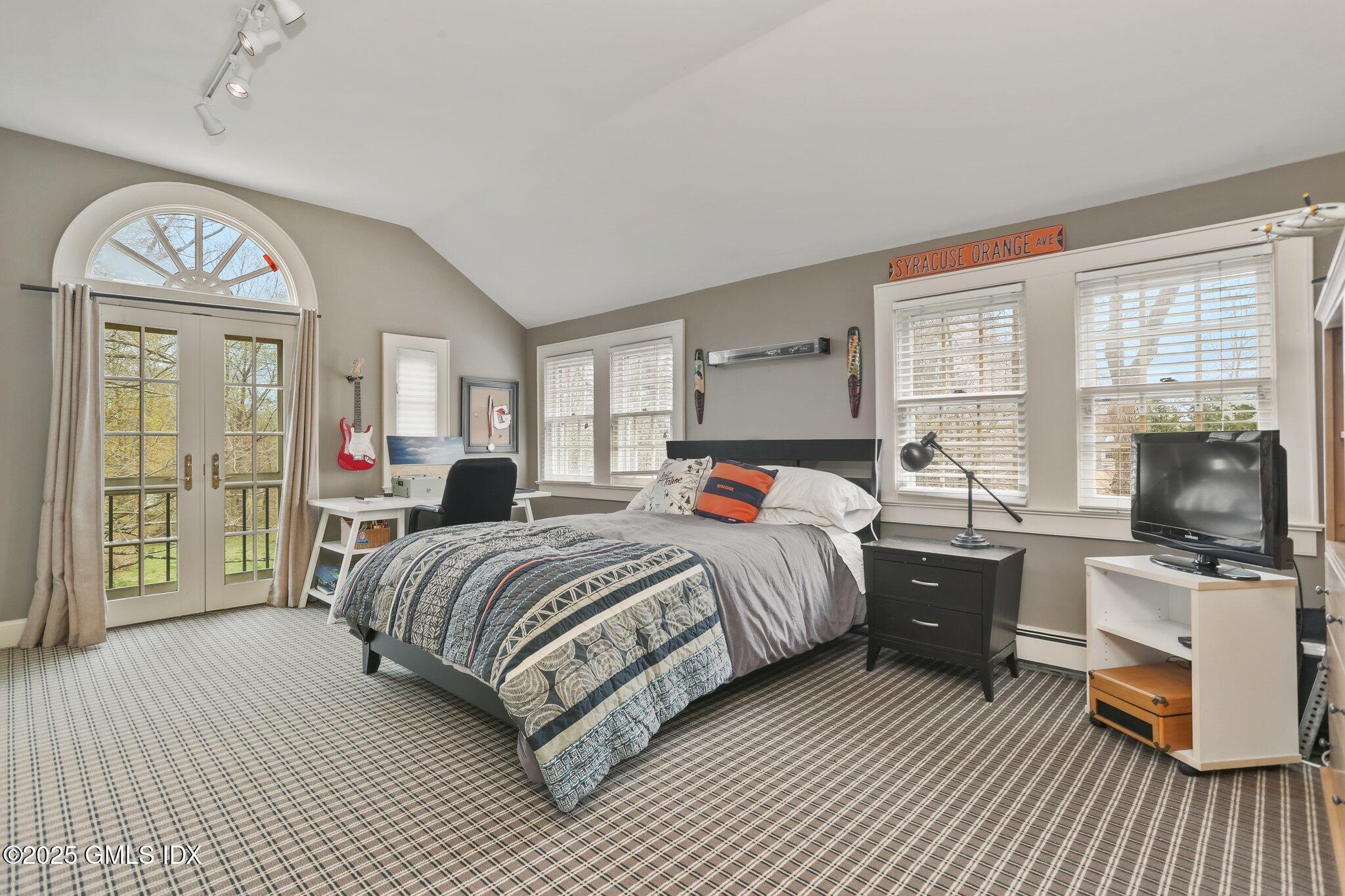 1007 King Street Greenwich, CT 06831 - Photo 41 of 71 a bed room with a bed and a television