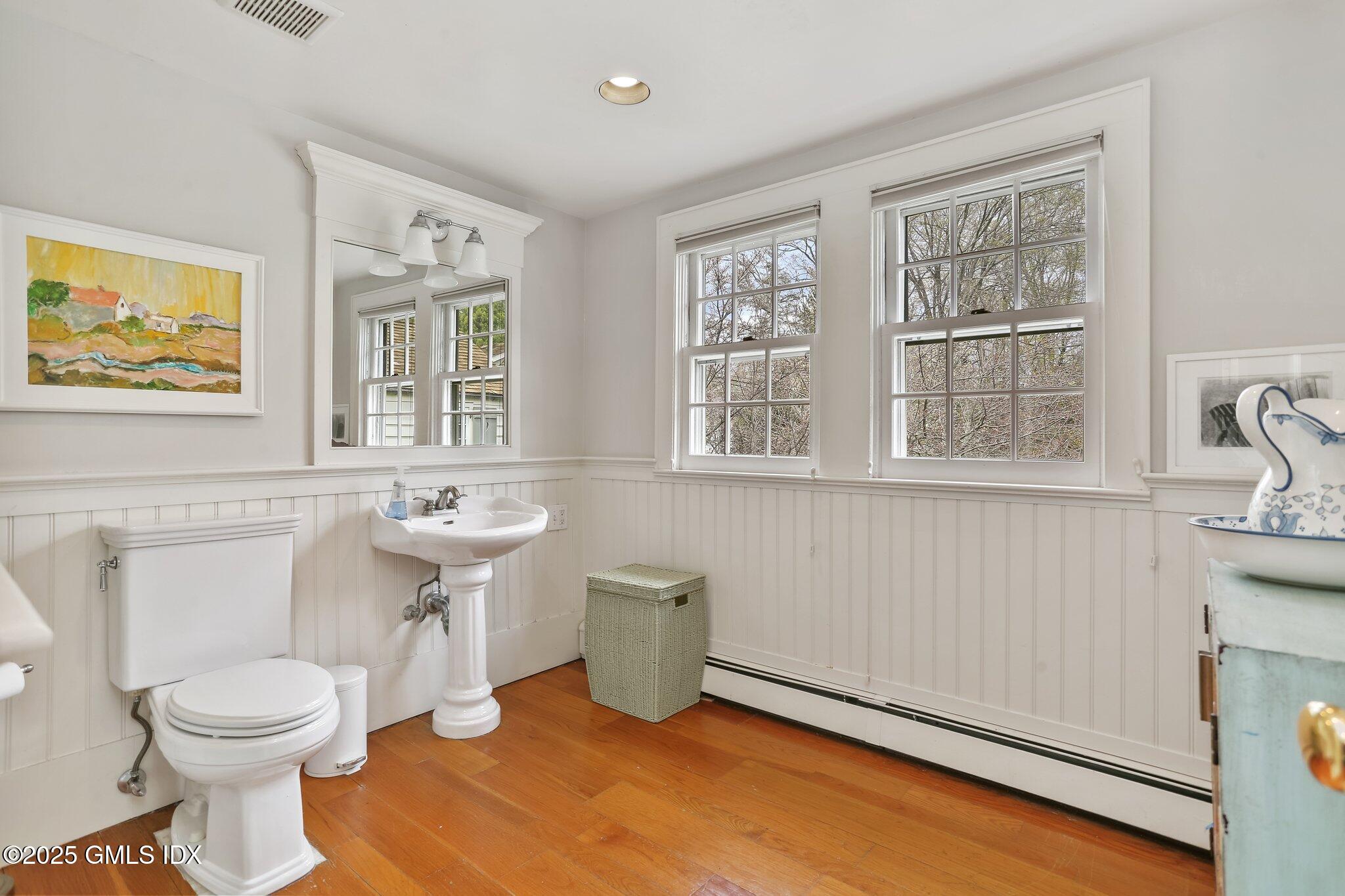 1007 King Street Greenwich, CT 06831 - Photo 45 of 71 a bathroom with a toilet sink and mirror