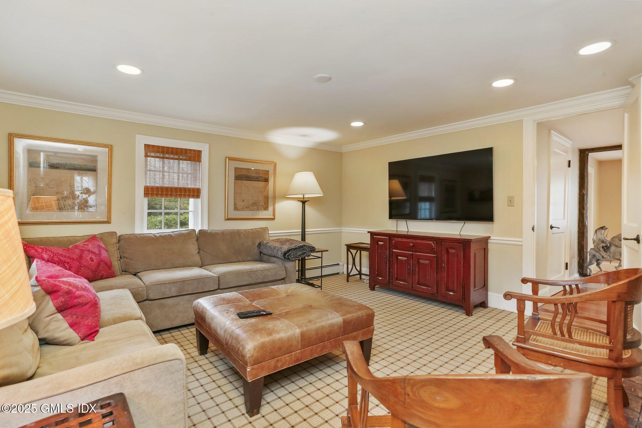 1007 King Street Greenwich, CT 06831 - Photo 5 of 71 a living room with furniture a flat screen tv and a large window