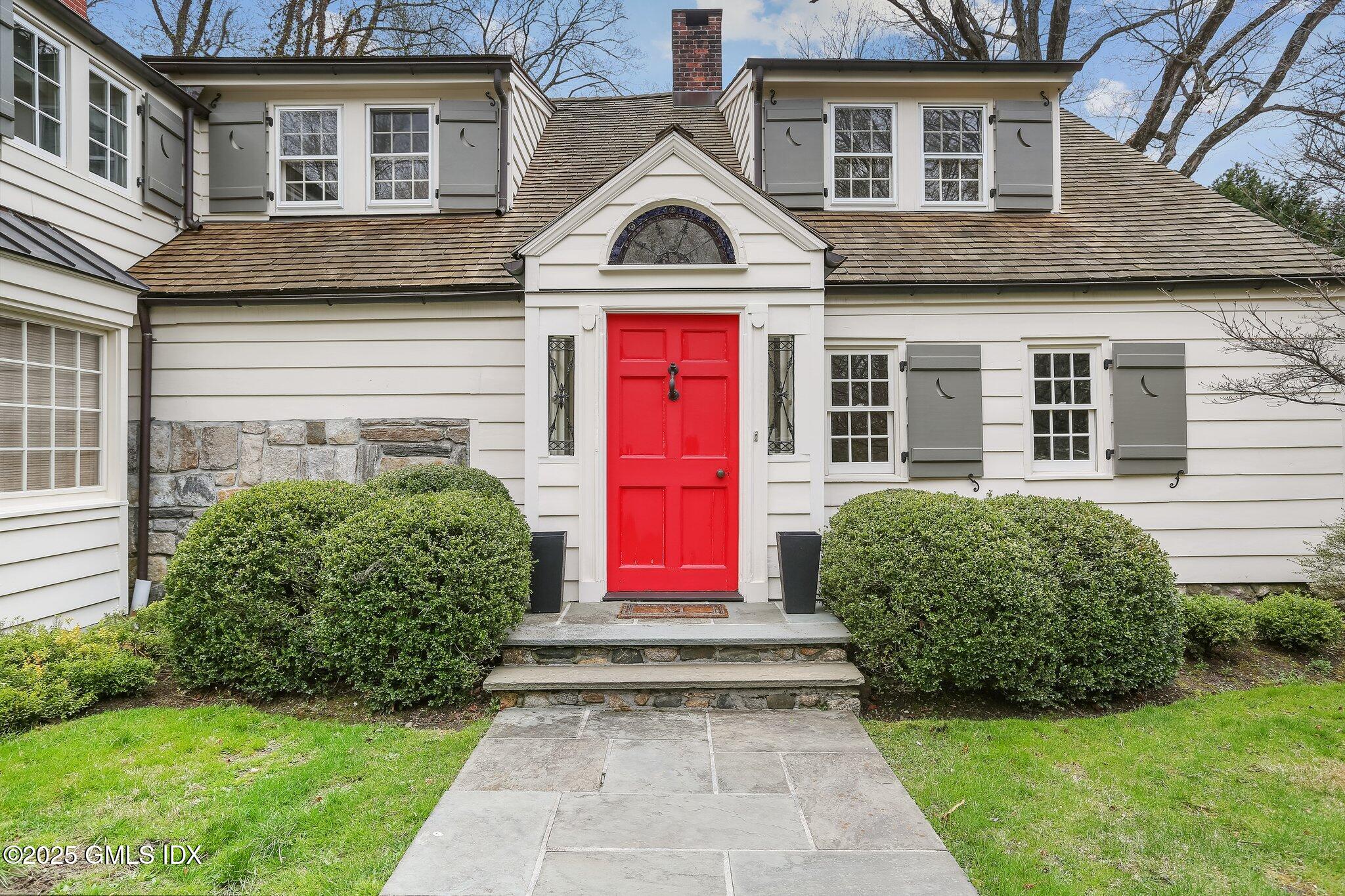 1007 King Street Greenwich, CT 06831 - Photo 60 of 71 a front view of a house with garden