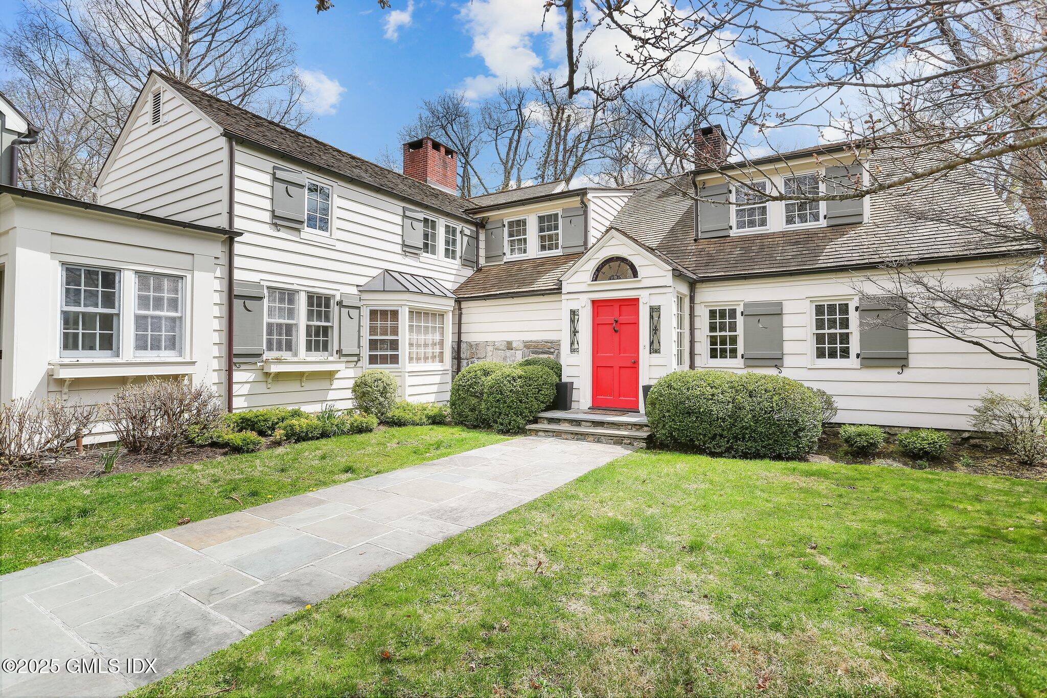 1007 King Street Greenwich, CT 06831 - Photo 61 of 71 a front view of a house with a yard and garage