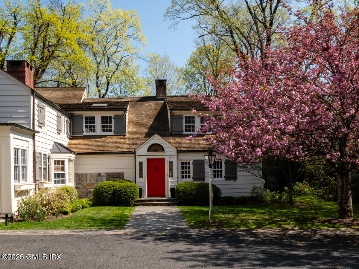 1007 King Street Greenwich, CT 06831 - Photo 63 of 71 a front view of a house with garden