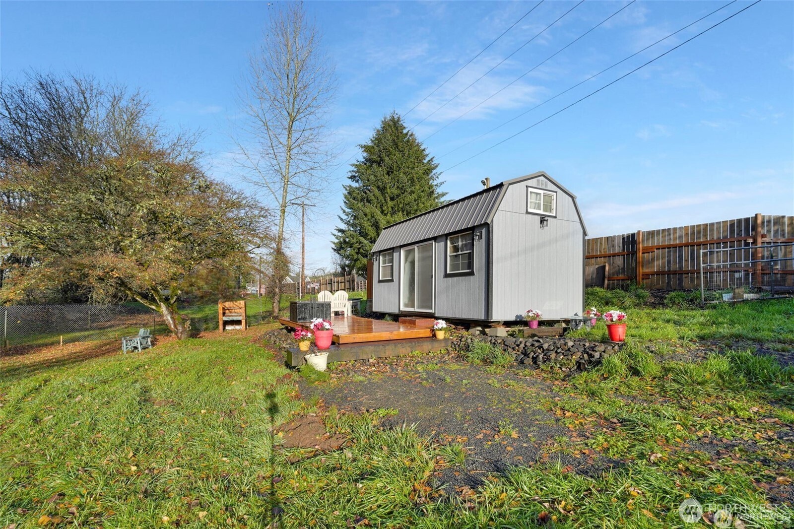 a view of a house with backyard and sitting area