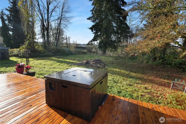 a balcony with wooden floor and lake view