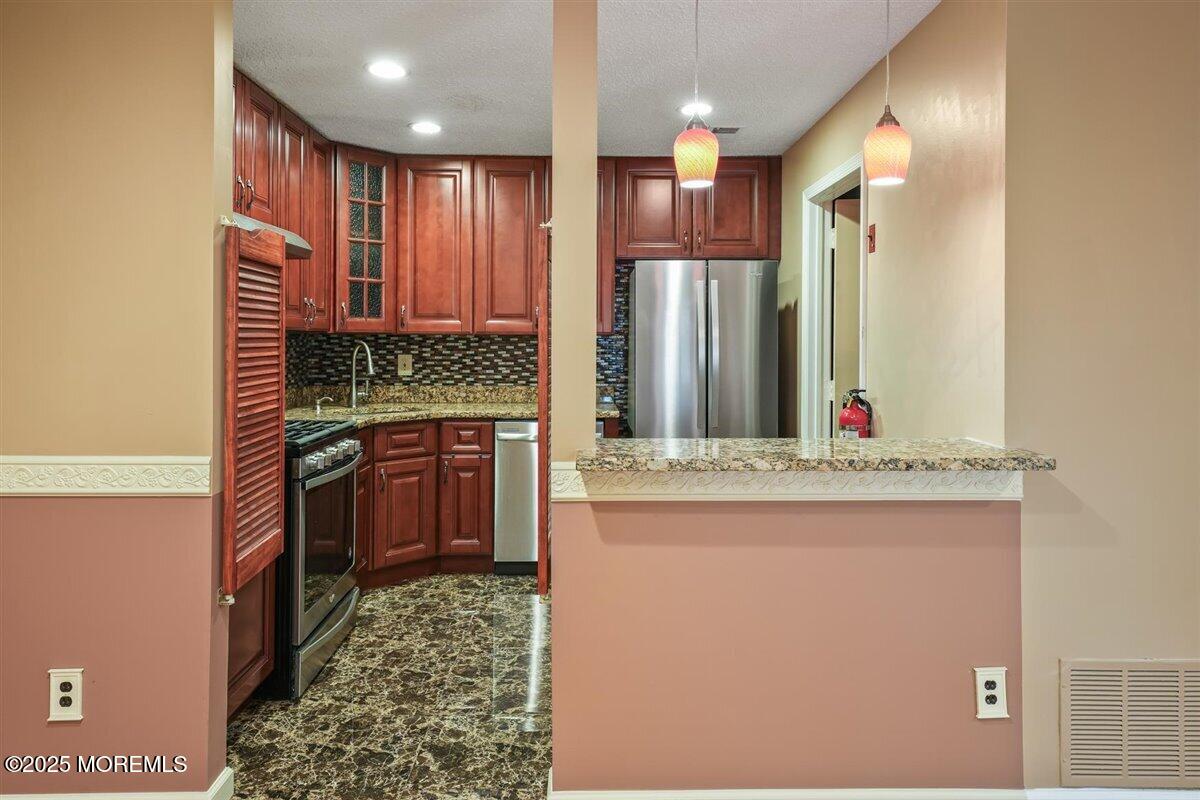 19 Augusta Court, Unit 8 Freehold, NJ 07728 - Photo 11 of 27 a bathroom with a double vanity sink and a mirror