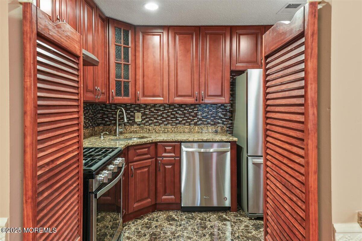 19 Augusta Court, Unit 8 Freehold, NJ 07728 - Photo 12 of 27 a bathroom with a sink and a mirror