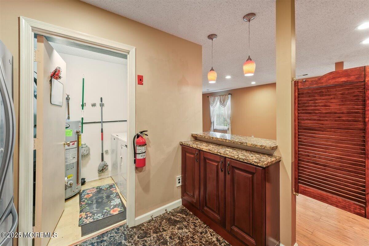 19 Augusta Court, Unit 8 Freehold, NJ 07728 - Photo 16 of 27 a view of a hallway with washer and dryer