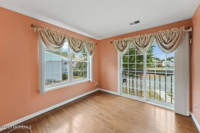 a view of an entryway door with wooden floor