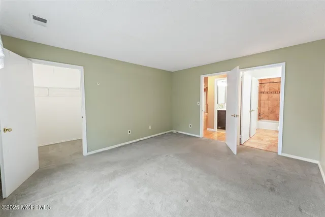a view of an empty room with glass door