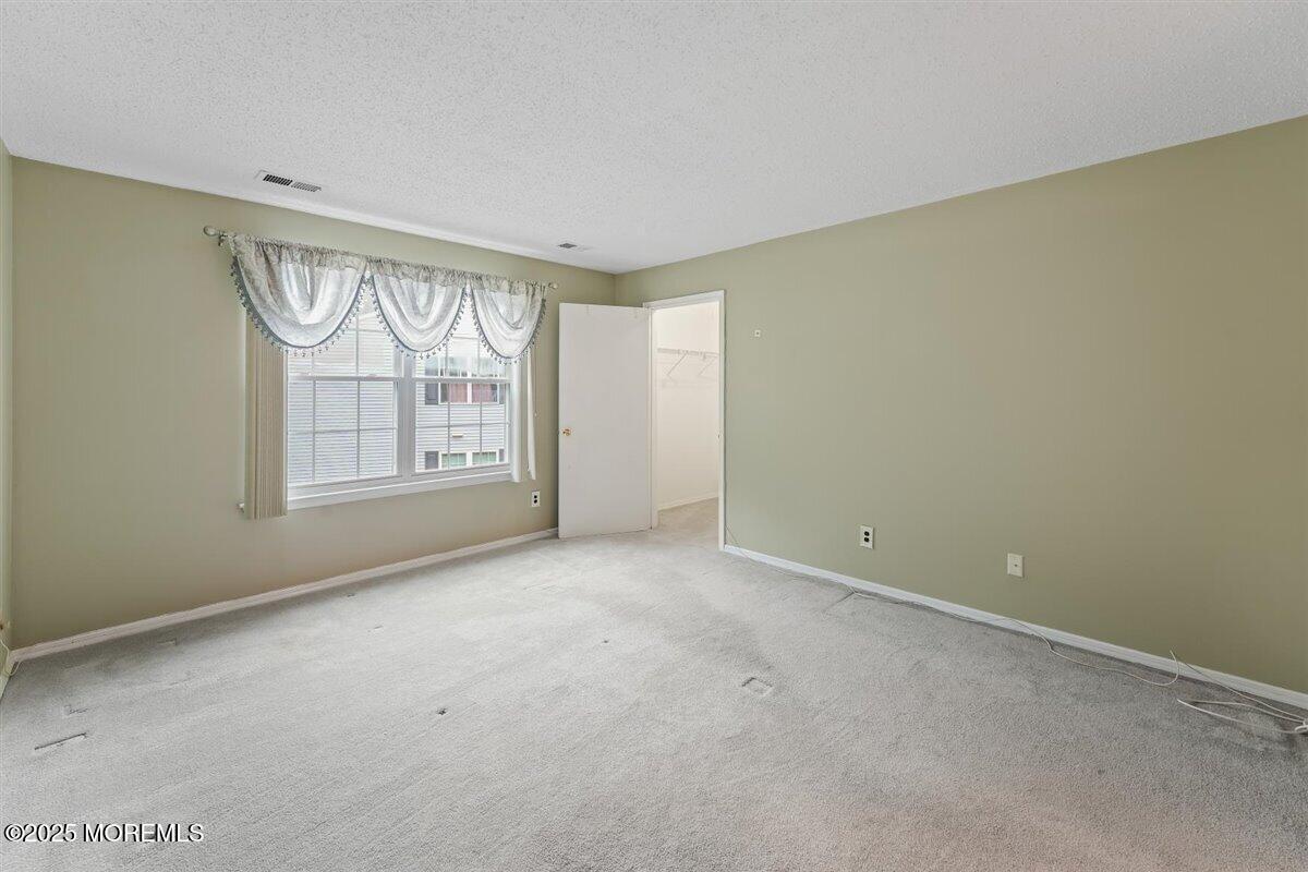 19 Augusta Court, Unit 8 Freehold, NJ 07728 - Photo 20 of 27 an empty room with windows