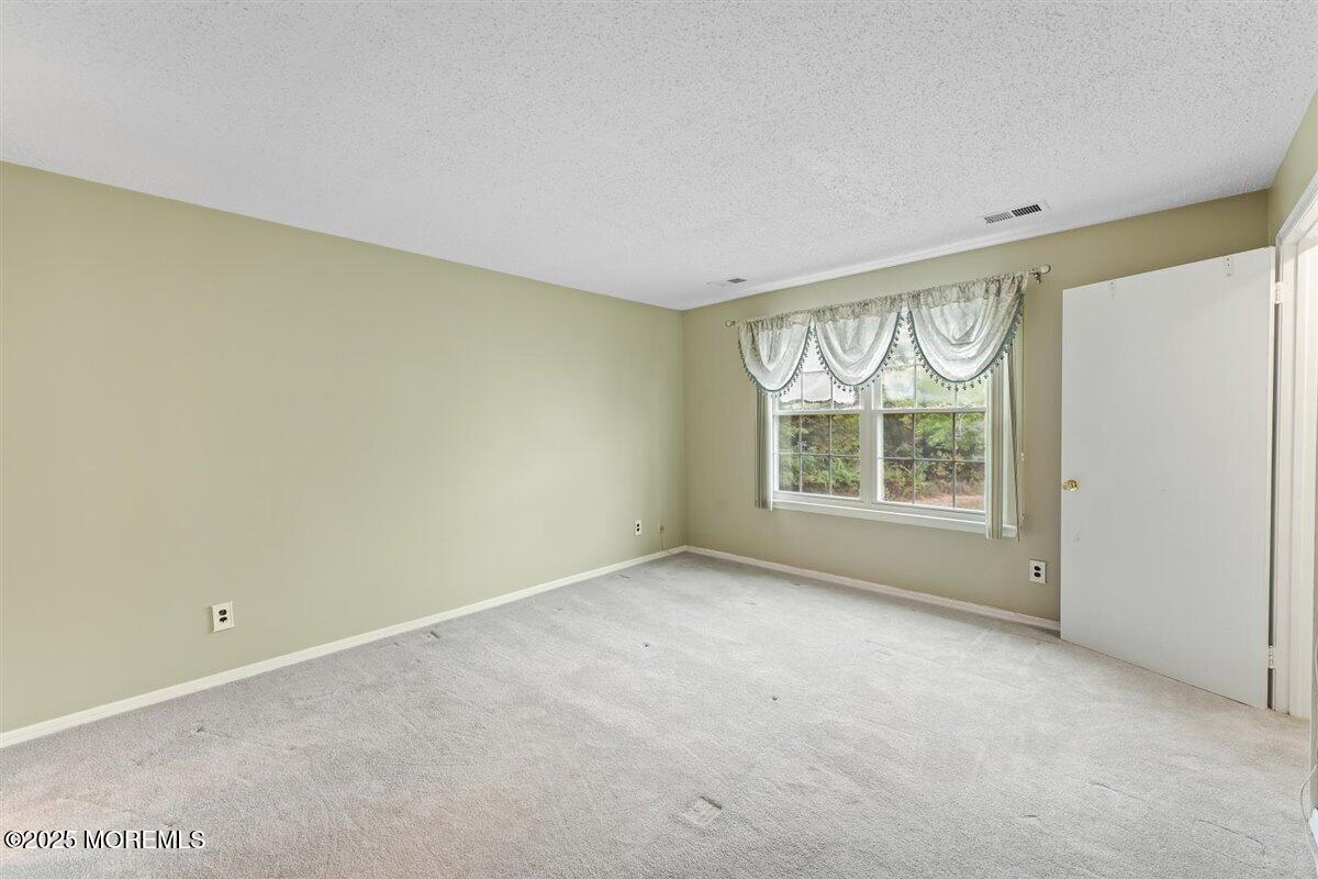 19 Augusta Court, Unit 8 Freehold, NJ 07728 - Photo 21 of 27 a view of an empty room with a window
