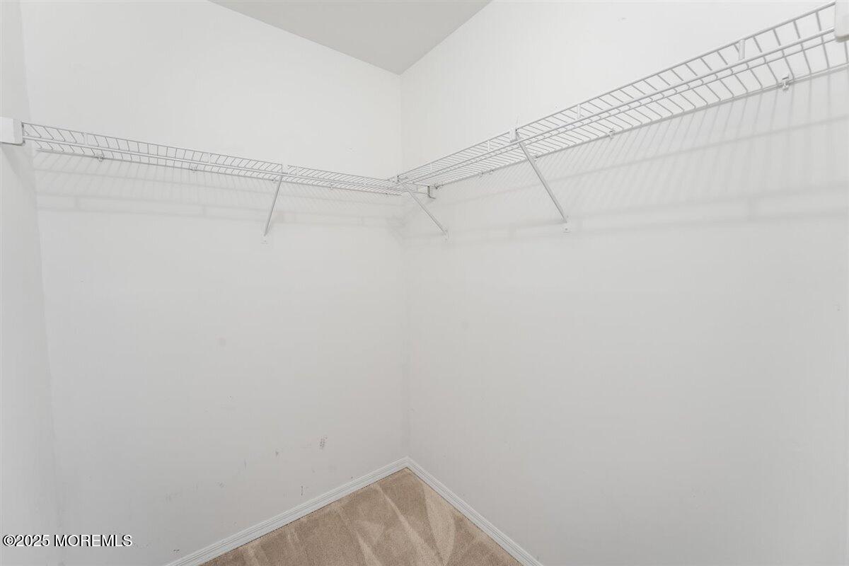 19 Augusta Court, Unit 8 Freehold, NJ 07728 - Photo 24 of 27 a view of a room with racks on the wall