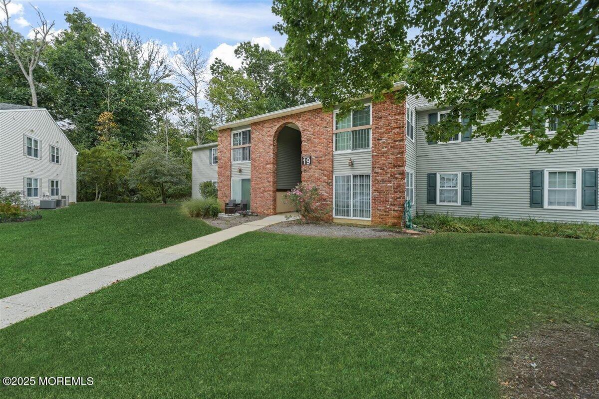19 Augusta Court, Unit 8 Freehold, NJ 07728 - Photo 3 of 27 a front view of house with yard and green space