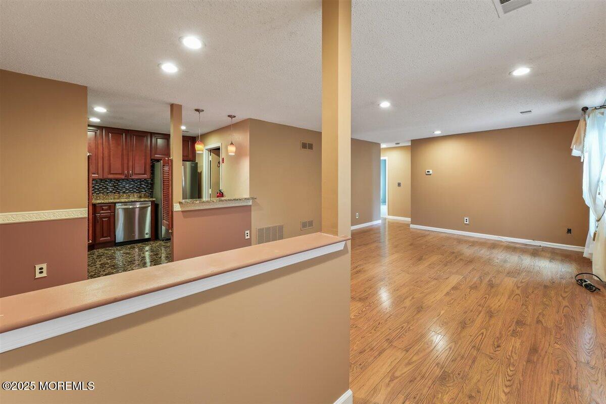 19 Augusta Court, Unit 8 Freehold, NJ 07728 - Photo 5 of 27 a kitchen with stainless steel appliances a refrigerator and a counter top