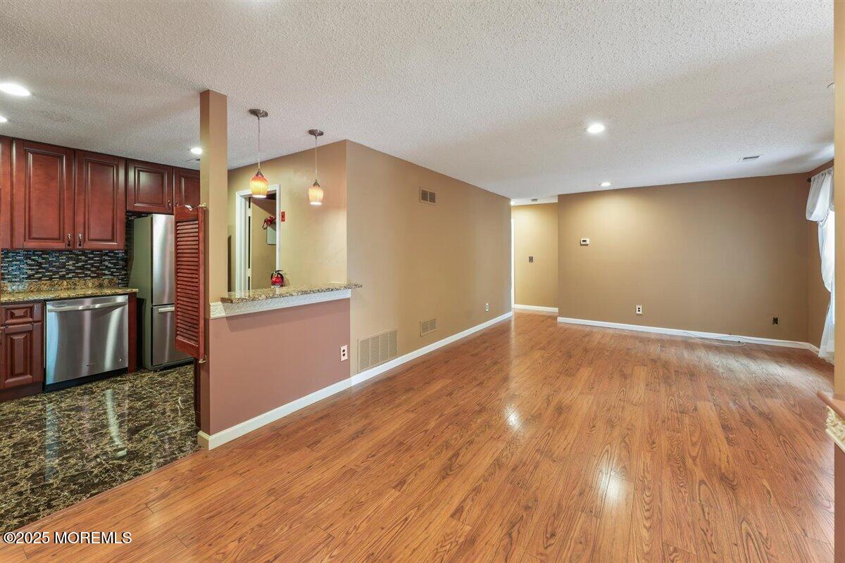19 Augusta Court, Unit 8 Freehold, NJ 07728 - Photo 8 of 27 a view of a kitchen with a sink and refrigerator
