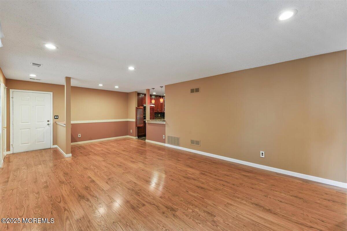 19 Augusta Court, Unit 8 Freehold, NJ 07728 - Photo 10 of 27 a view of empty room with wooden floor