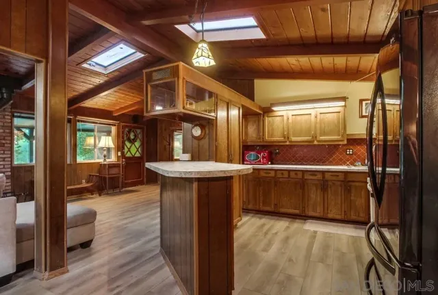 a kitchen with sink and refrigerator