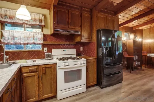 a kitchen with a stove and a refrigerator