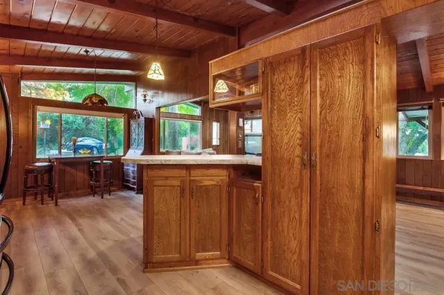 a living room with large windows and furniture