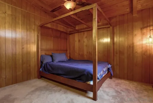a bed sitting in a room next to a wooden door