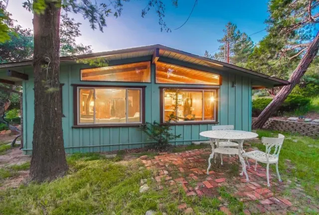 a backyard of a house with table and chairs