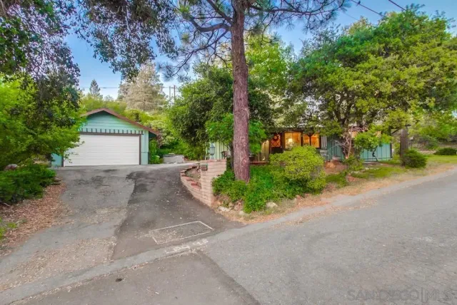 a front view of a house with a yard and a garage