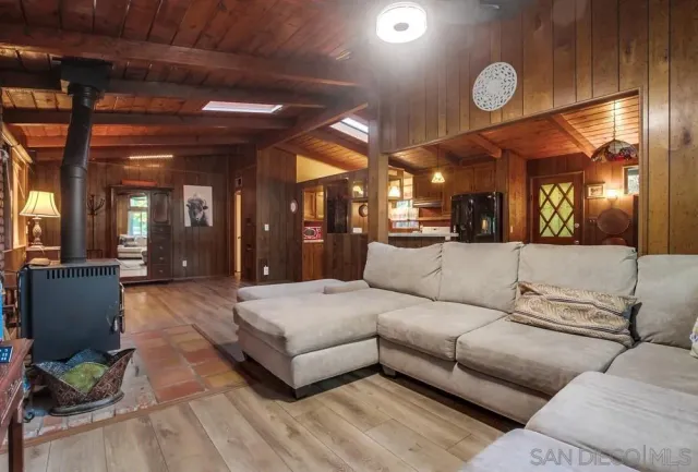 a large living room with furniture and a large mirror