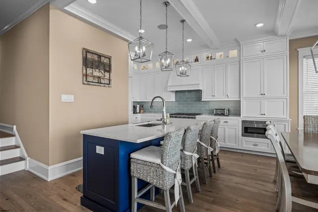 a kitchen with white cabinets and appliances