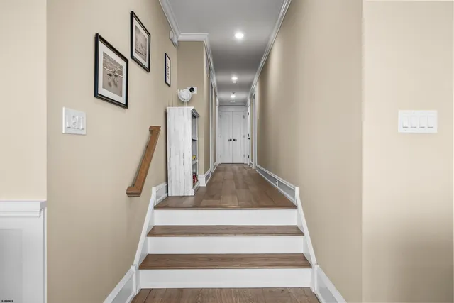 a bedroom with a large bed and a flat tv screen