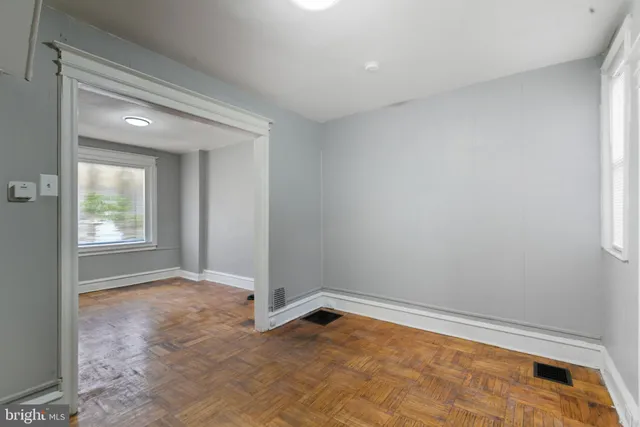 wooden floor in an empty room with a window