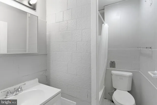 a white toilet sitting next to a bathroom sink
