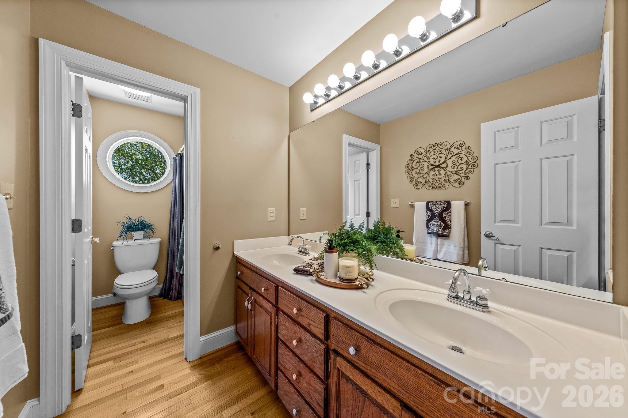 3530 Cardiff Lane Matthews, NC 28104 - Photo 31 of 39 a bathroom with a granite countertop sink and a mirror