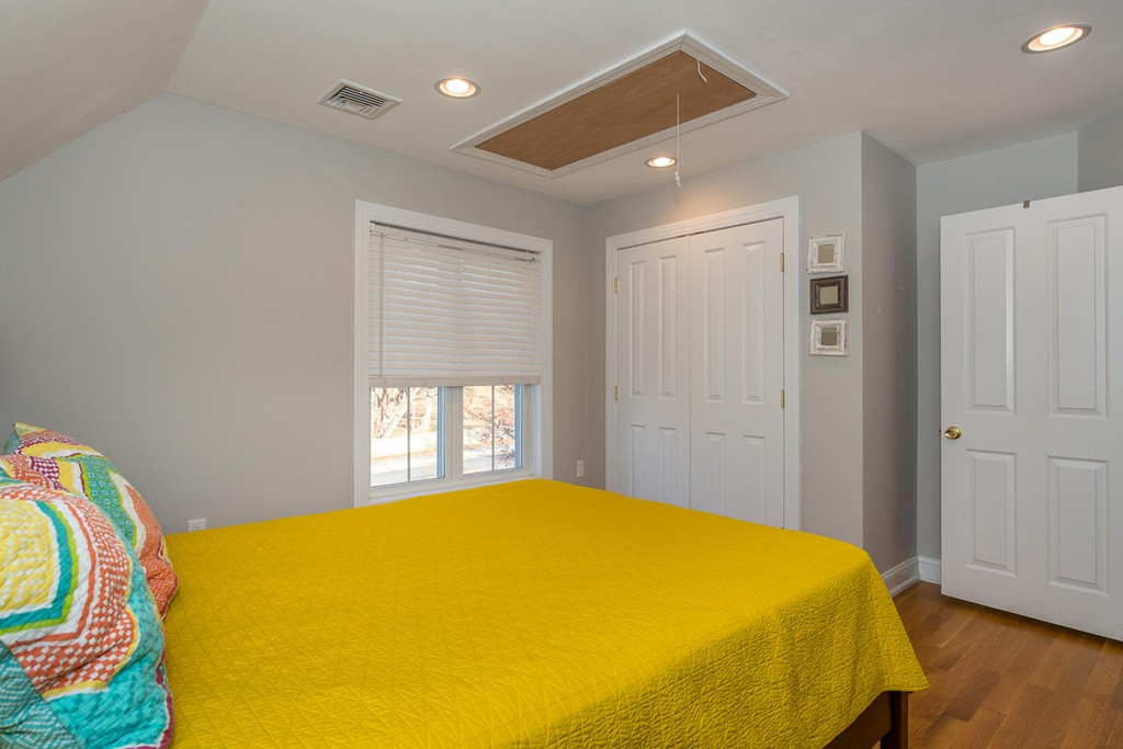 136 Sherman Street Canton, MA 02021 - Photo 15 of 17 a bedroom with a bed and wooden floor