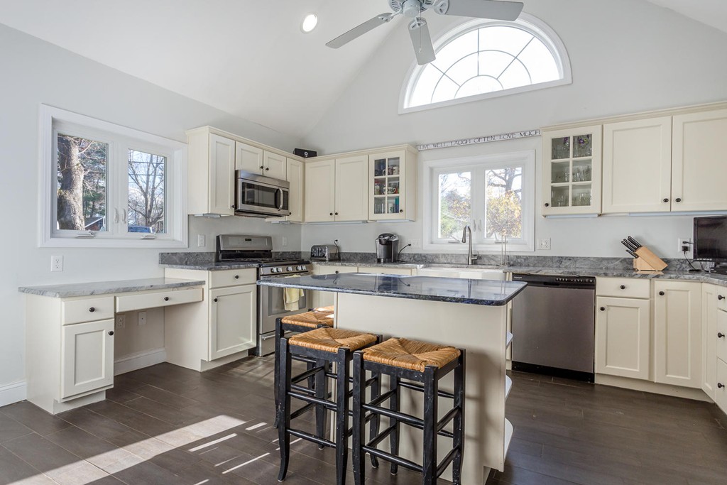 136 Sherman Street Canton, MA 02021 - Photo 7 of 17 a kitchen with stainless steel appliances granite countertop a stove a sink dishwasher a microwave oven a stove with white cabinets and wooden floor