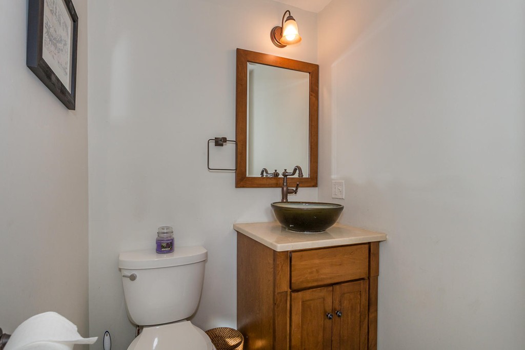 136 Sherman Street Canton, MA 02021 - Photo 9 of 17 a bathroom with a toilet sink and mirror